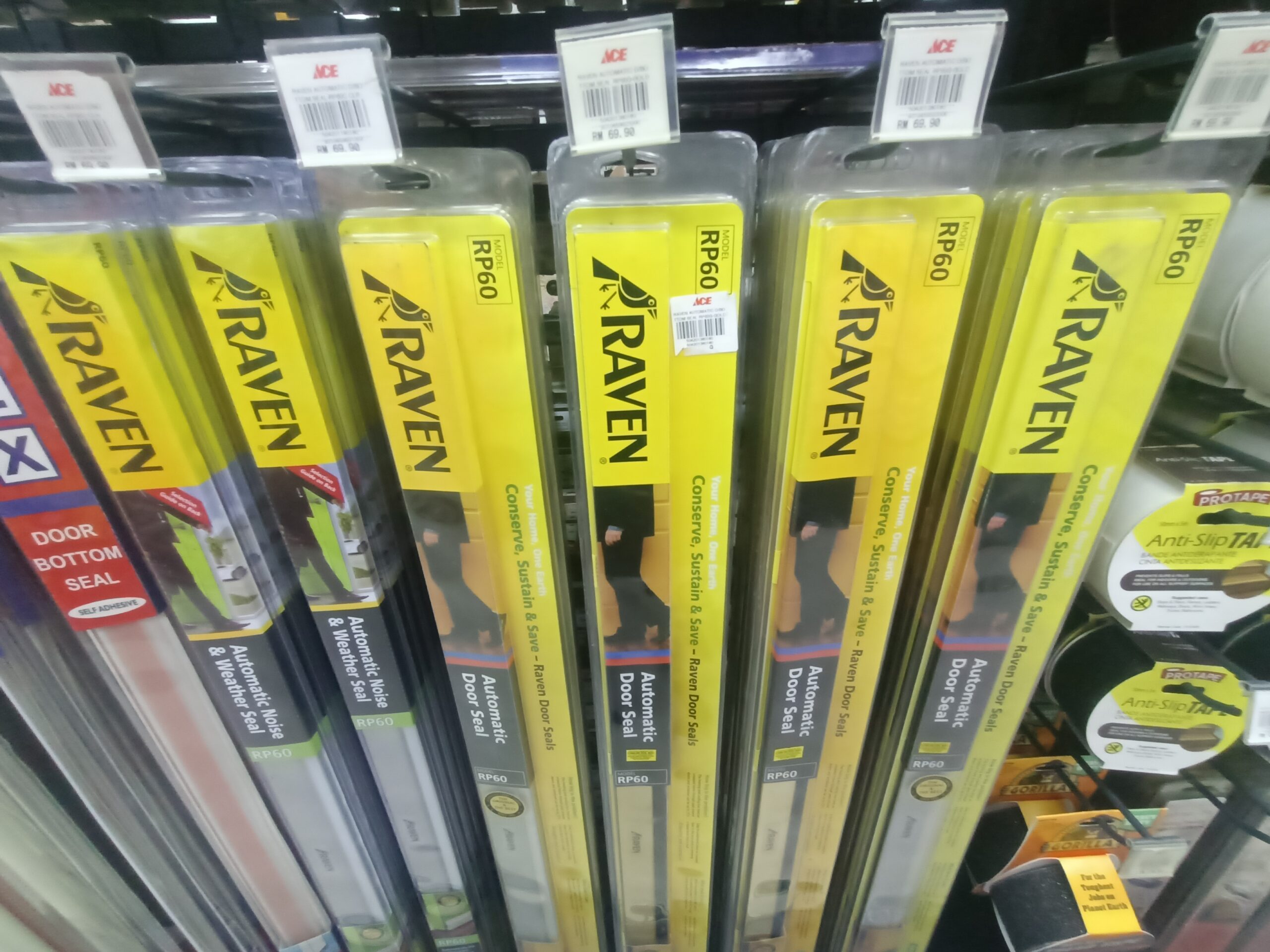 A selection of door sweeps and door seals on sale in a homeware store.