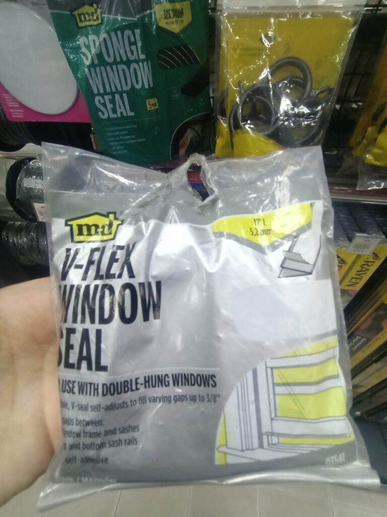 Customer holding a window seal kit in a hardware store.