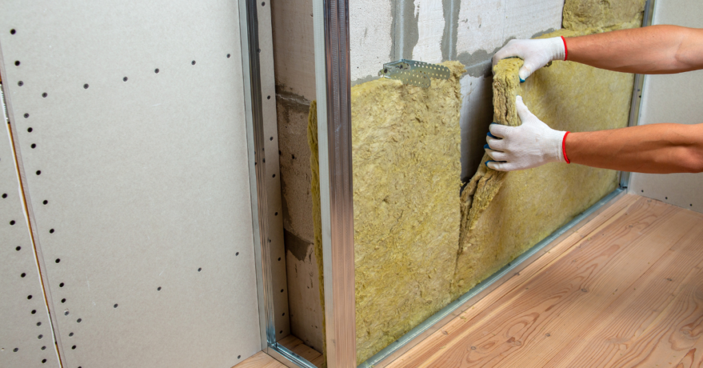 Mineral wool installation being installed into a wall.