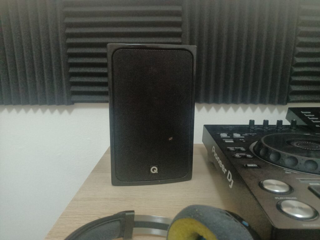 Acoustic foam behind a speaker on the rear wall of a studio.